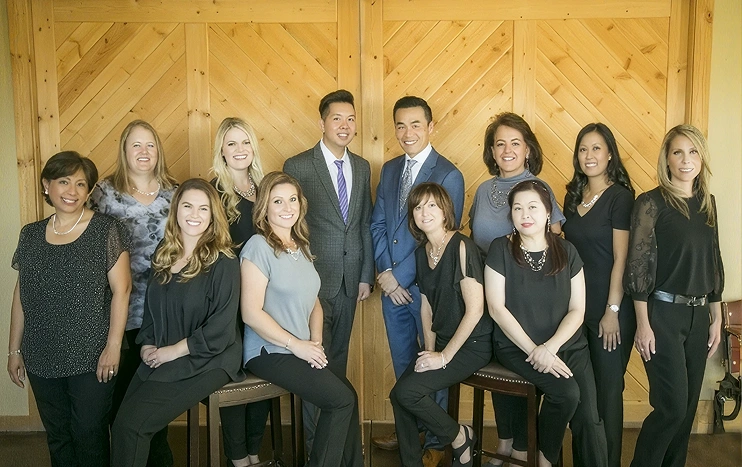 Veterinary care team members posing together indoors.